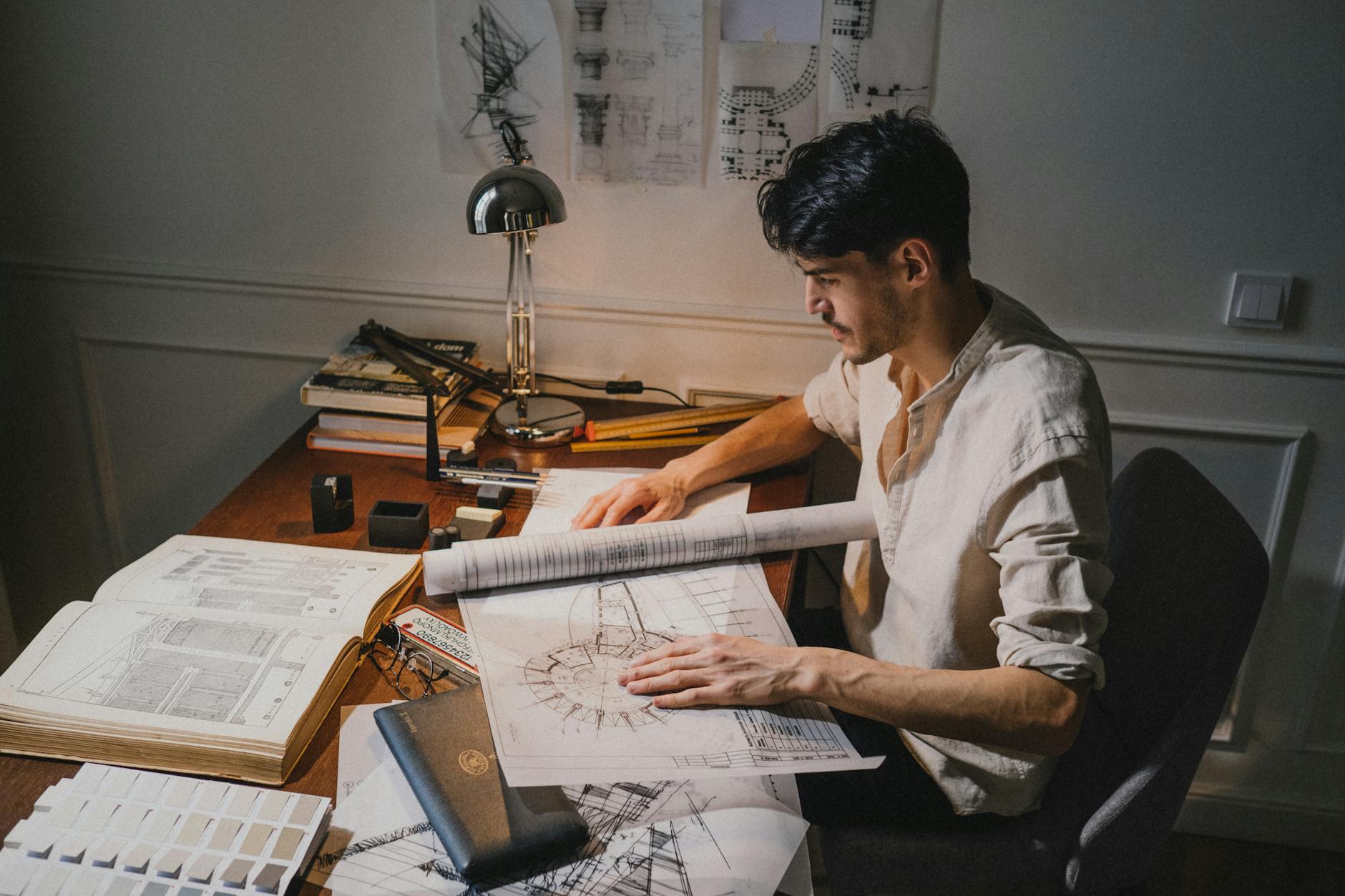 Architect's desk with drawings in warm light